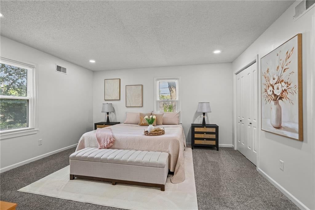 Main-floor primary bedroom and carpet at 2404 NE 60TH Street, Gladstone, MO 64118