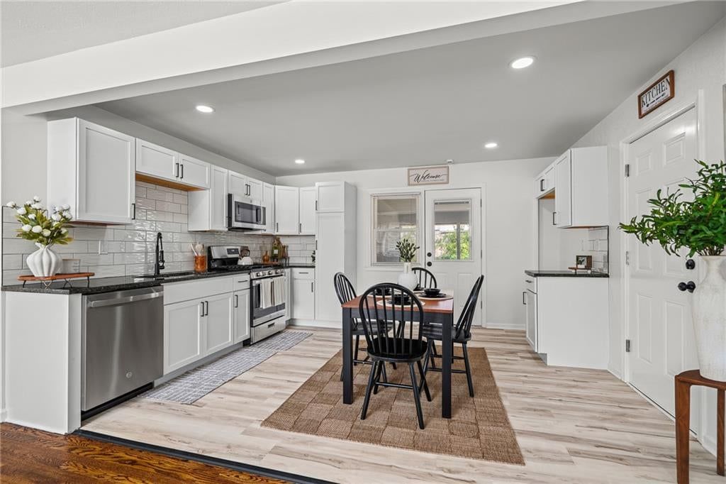 White kitchen, gas range and shaker cabinets at 2404 NE 60TH Street, Gladstone, MO 64118