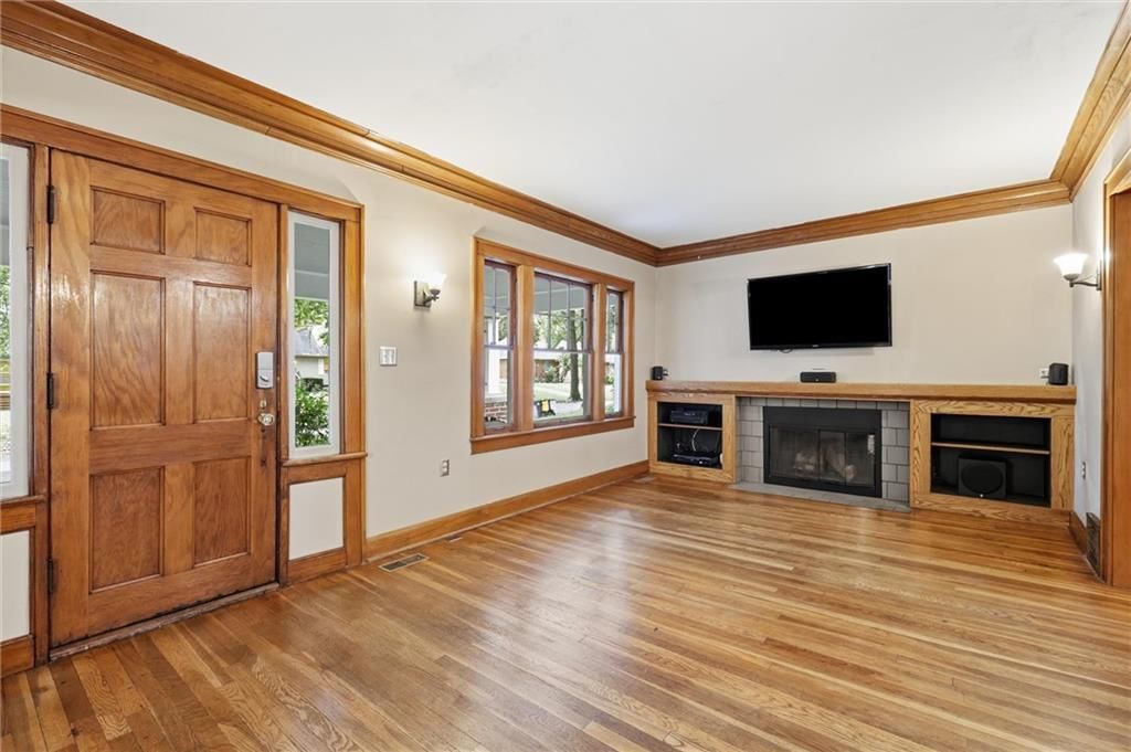 Fireplace, open floor plan and hardwood floors at 7516 Locust Street, Kansas City, MO 64131