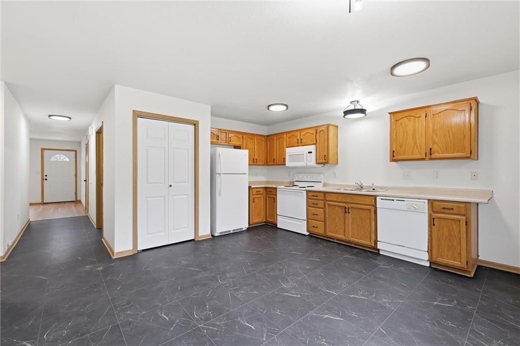 Tile floors, breakfast nook and wood kitchen cabinets at 212/14 NW 27th St. Court, Blue Springs, MO 64015