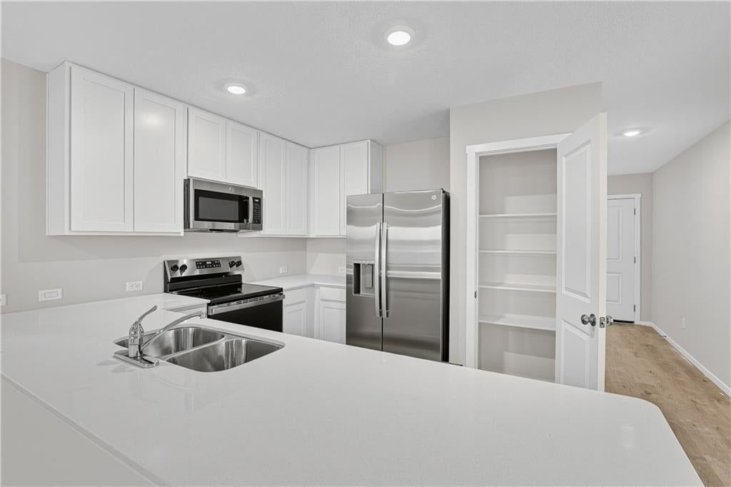 White kitchen, shaker cabinets and stainless steel appliances at 38011 W 207th Terrace, Edgerton, KS 66021