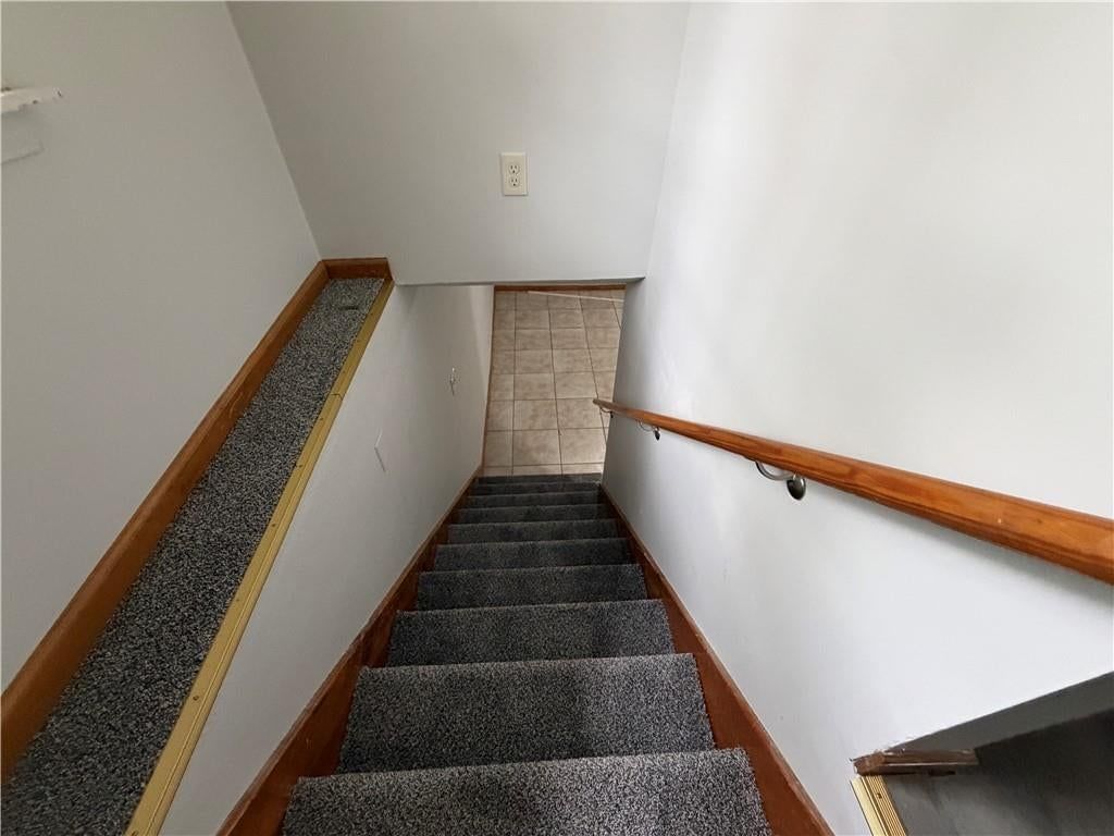 Staircase and wood stair railing at 1305 Farview Drive, Independence, MO 64056