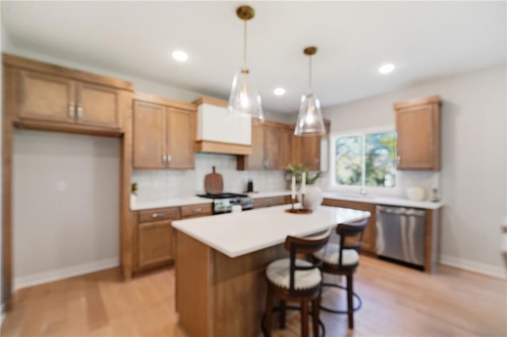 Kitchen island, quartz counters and gas range at 18360 W 195th Street, Spring Hill, KS 66083