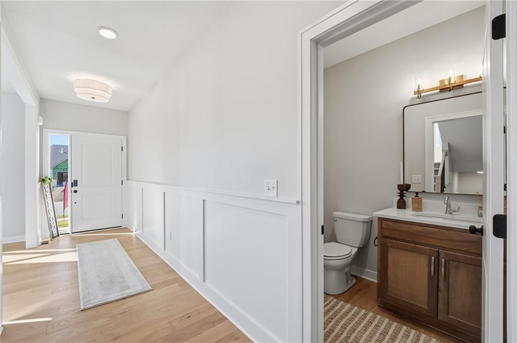 Wainscoting or board and batten, shiplap / paneling and black hardware at 18360 W 195th Street, Spring Hill, KS 66083