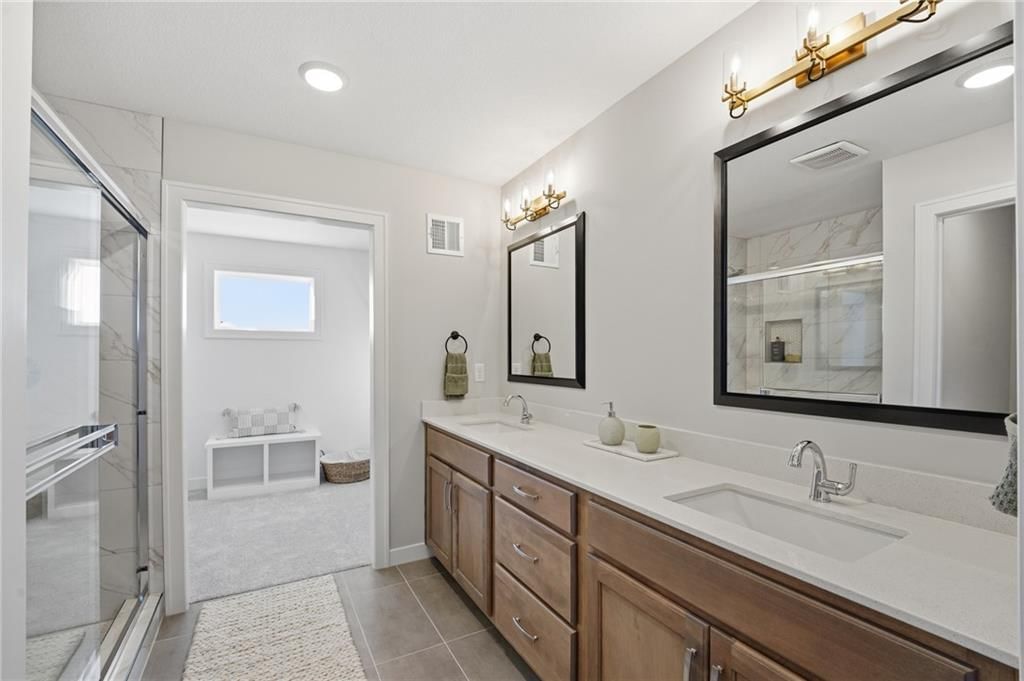 Double vanity, wood vanity and renovated bathrooms at 18360 W 195th Street, Spring Hill, KS 66083
