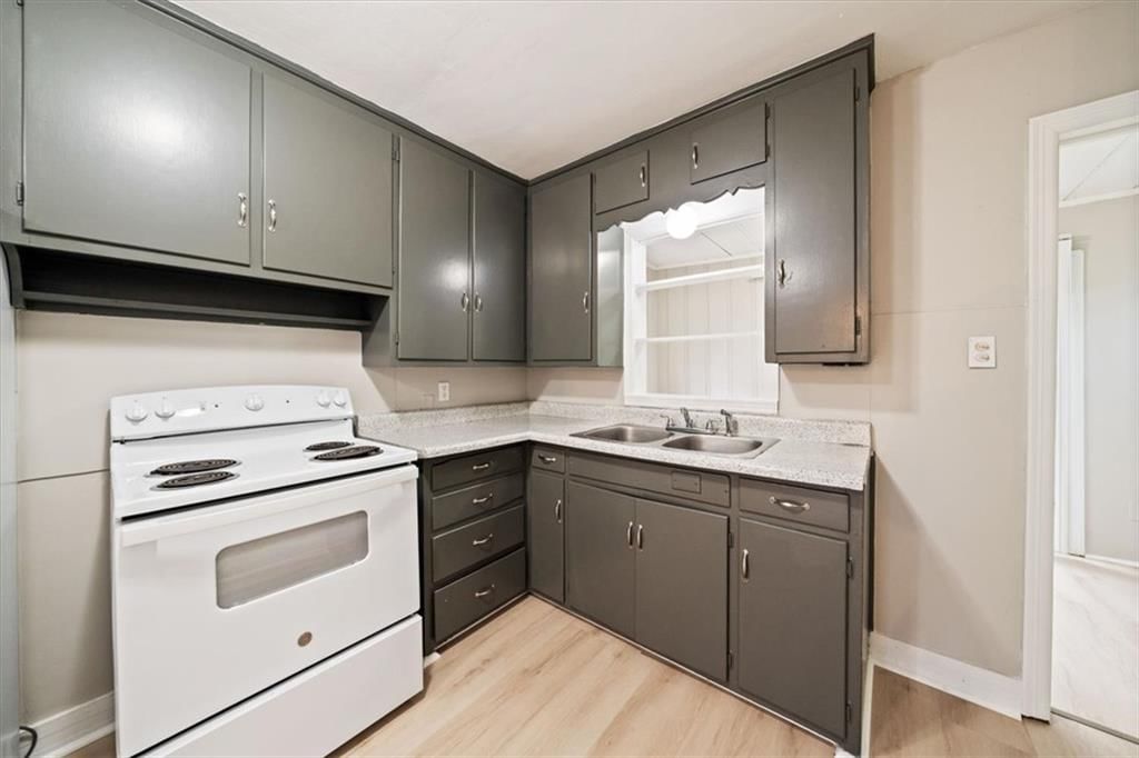 White appliances, electric range and dark kitchen cabinets at 11503 HACKETT Street, Sugar Creek, MO 64054
