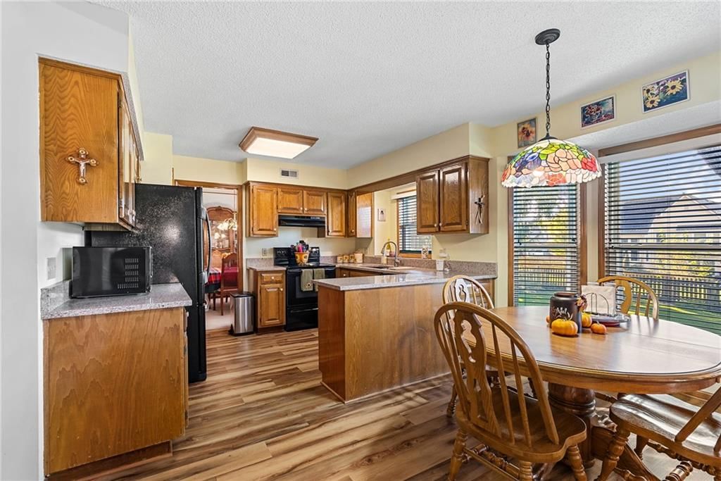 Electric range and black appliances at 811 N Mesa Street, Olathe, KS 66061