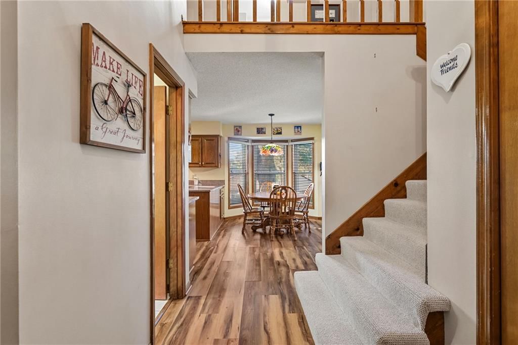 Luxury vinyl floors, staircase and wood stair railing at 811 N Mesa Street, Olathe, KS 66061