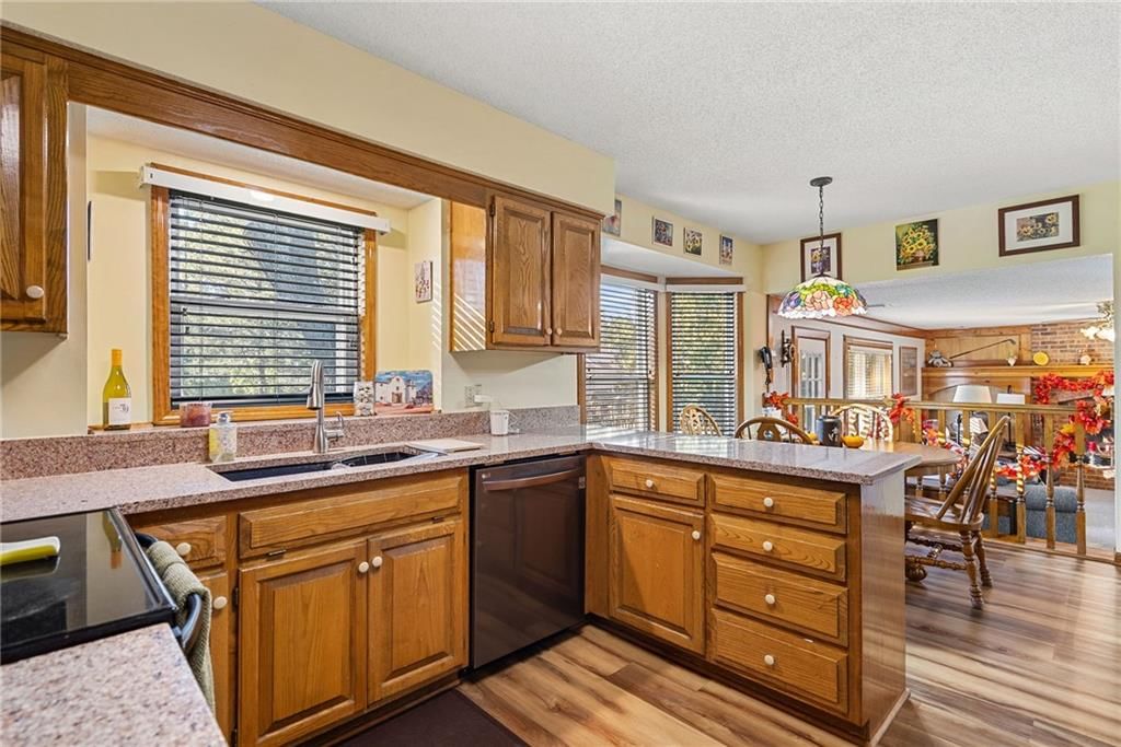 Wood kitchen cabinets, beige or brown countertops and raised-panel cabinets at 811 N Mesa Street, Olathe, KS 66061