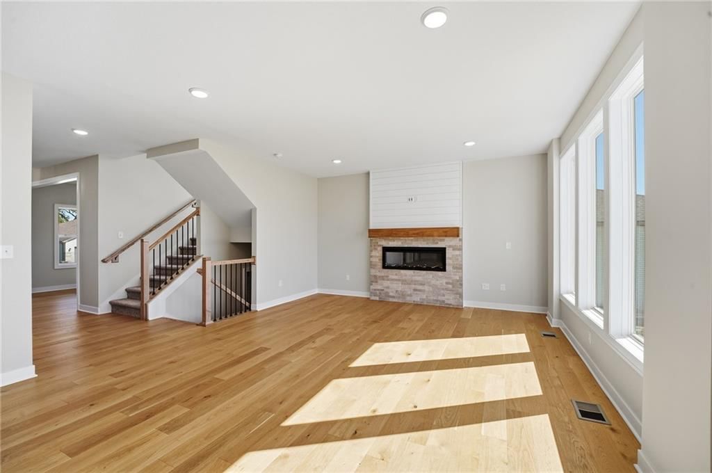 Fireplace, shiplap / paneling and wall of windows at 18425 W 195th Street, Spring Hill, KS 66083