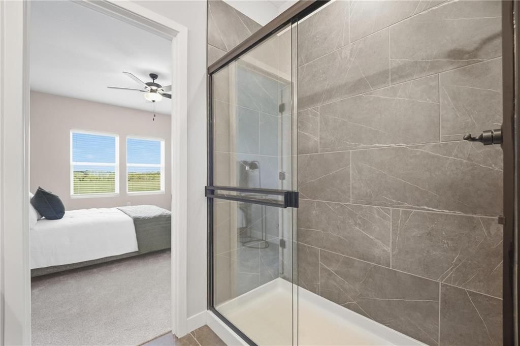 Walk-in shower and tiled shower at 1212 SE Ranchland Drive, Lee's Summit, MO 64081