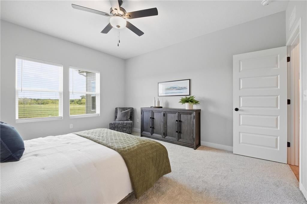 Main-floor primary bedroom and carpet at 1212 SE Ranchland Drive, Lee's Summit, MO 64081