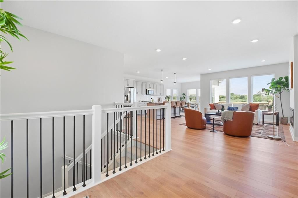 Open floor plan, kitchen island and stainless steel appliances at 1212 SE Ranchland Drive, Lee's Summit, MO 64081