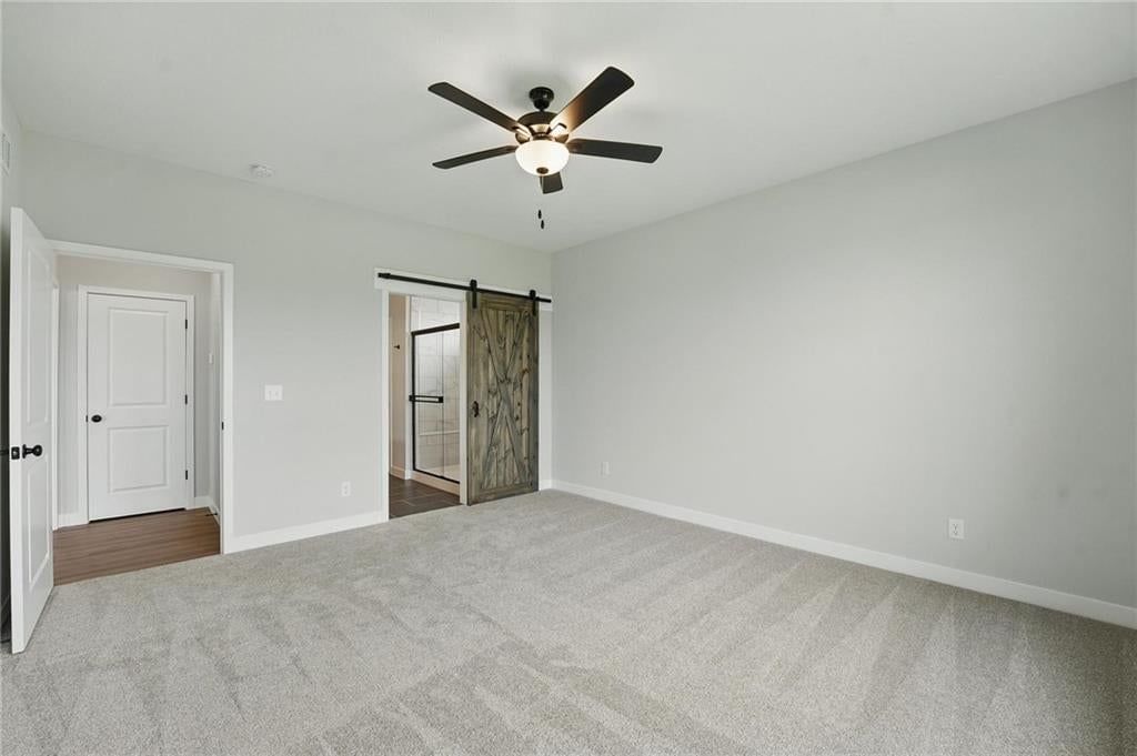 Main-floor primary bedroom and black hardware at 27016 E Olive Drive, Lee's Summit, MO 64086