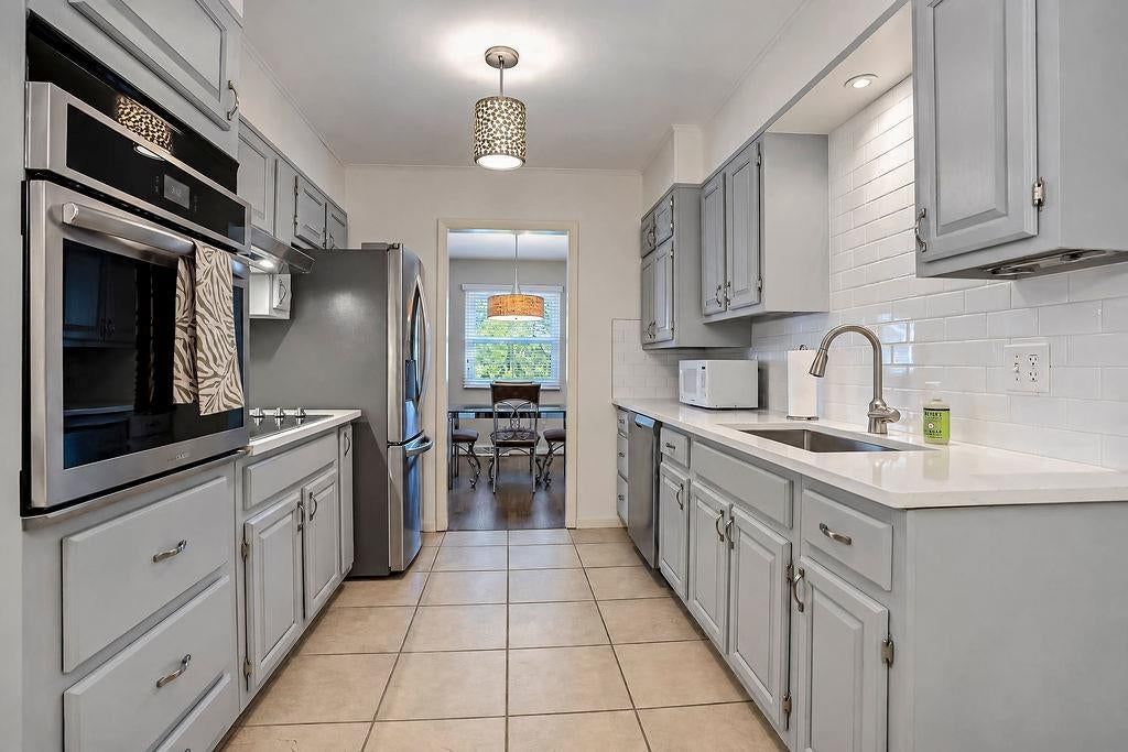 Kitchen backsplash, subway tile backsplash and white countertops at 3109 W 79th Terrace, Prairie Village, KS 66208