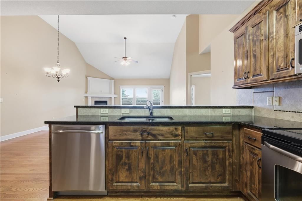 Kitchen island and kitchen backsplash at 811 NE Lone Hill Drive, Lee's Summit, MO 64064