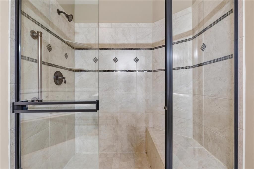 Walk-in shower, tiled shower and frameless glass shower at 811 NE Lone Hill Drive, Lee's Summit, MO 64064