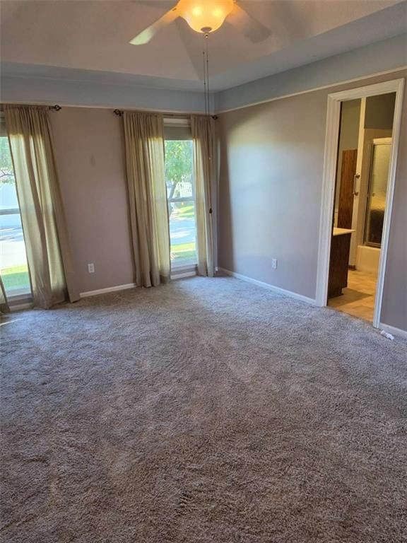 Main-floor primary bedroom and tray ceiling at 9704 N Locust Drive, Kansas City, MO 64155