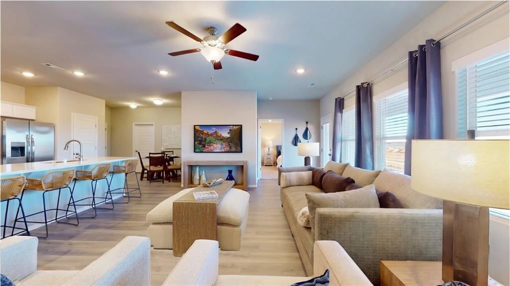 Fireplace, open floor plan and statement lighting at 701 SW 6th Terrace, Oak Grove, MO 64075