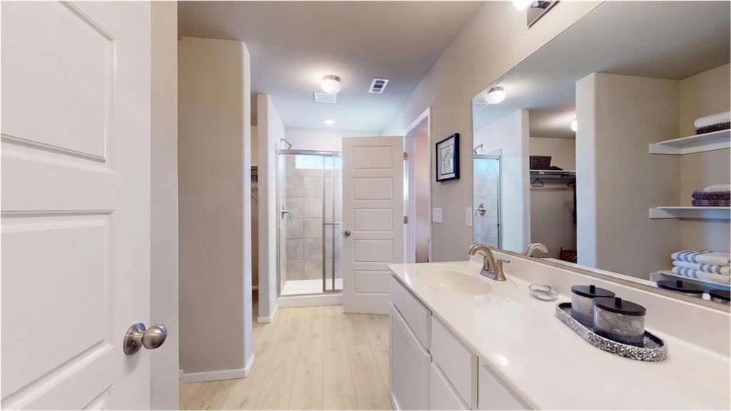 Walk-in shower, tiled shower and double vanity at 701 SW 6th Terrace, Oak Grove, MO 64075