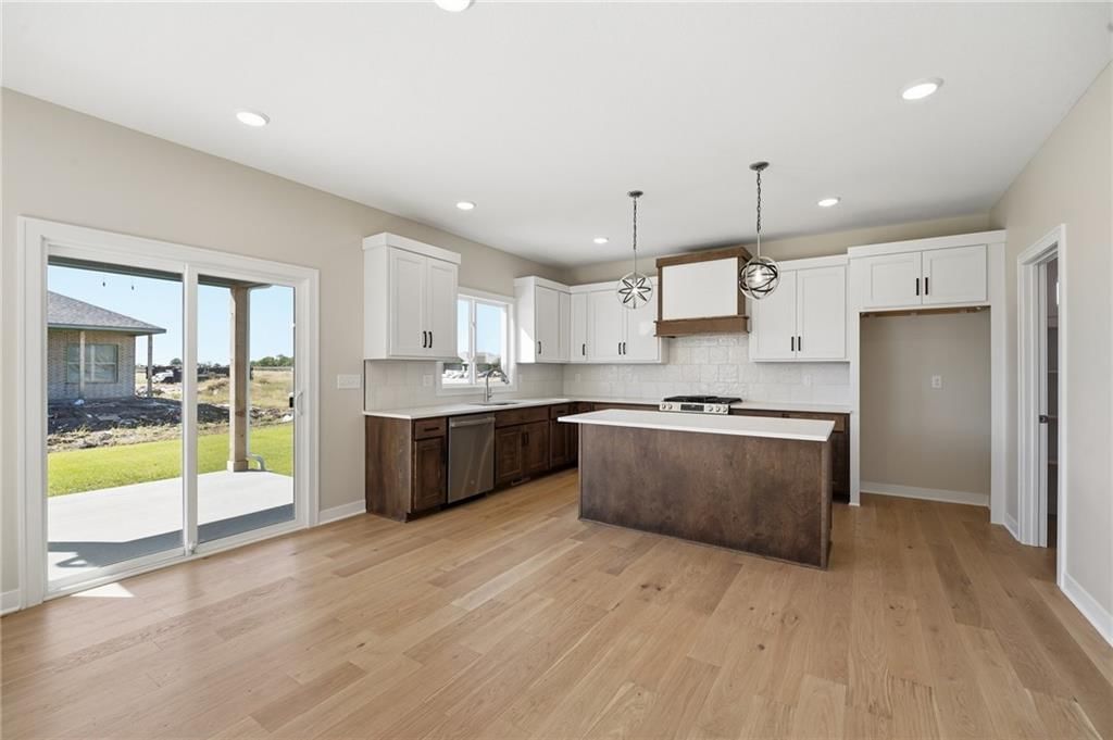Kitchen island, quartz counters and gas range at 18455 W 195th Street, Spring Hill, KS 66083
