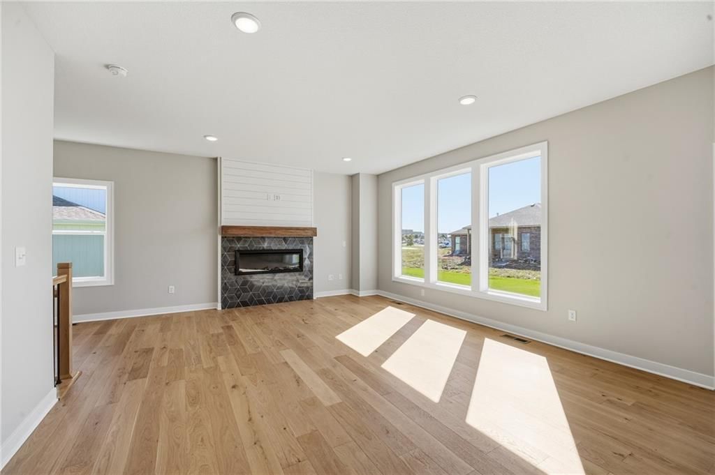 Fireplace, shiplap / paneling and tile fireplace at 18455 W 195th Street, Spring Hill, KS 66083