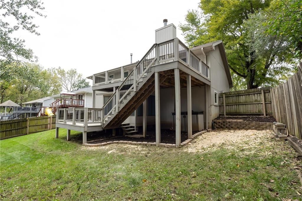 Fenced yard, mature trees and flat lot at 140 Debra Street, Lansing, KS 66043