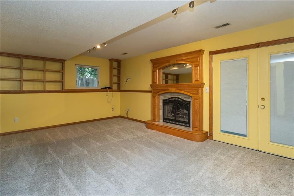 Finished basement and fireplace at 140 Debra Street, Lansing, KS 66043