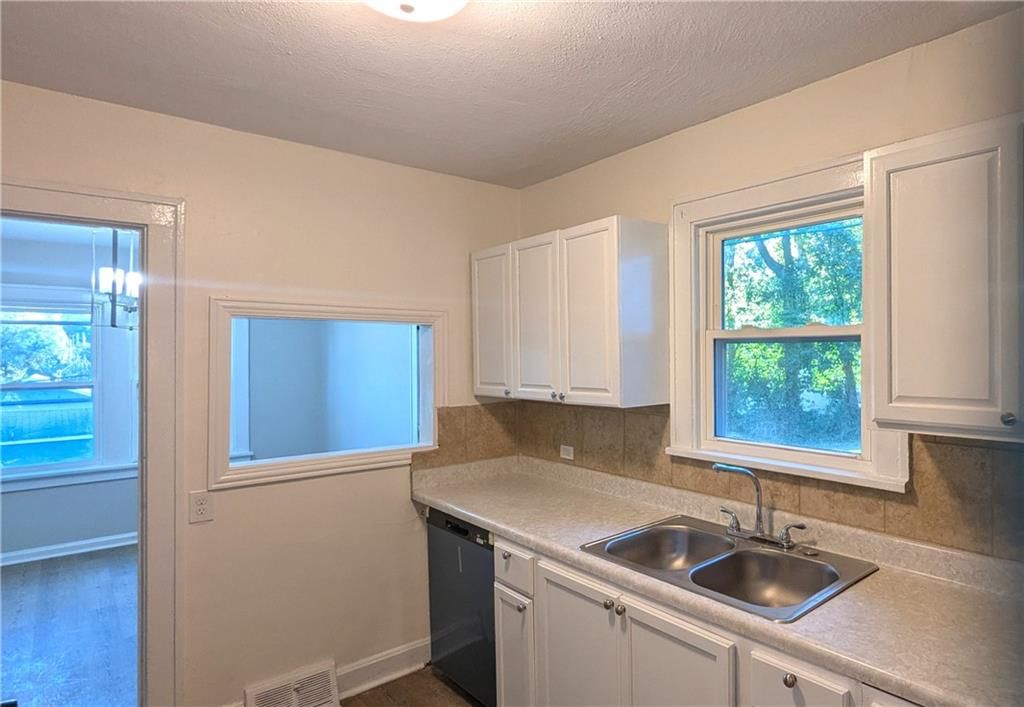 White kitchen, kitchen backsplash and raised-panel cabinets at 439 E Aberdeen Street, Independence, MO 64055