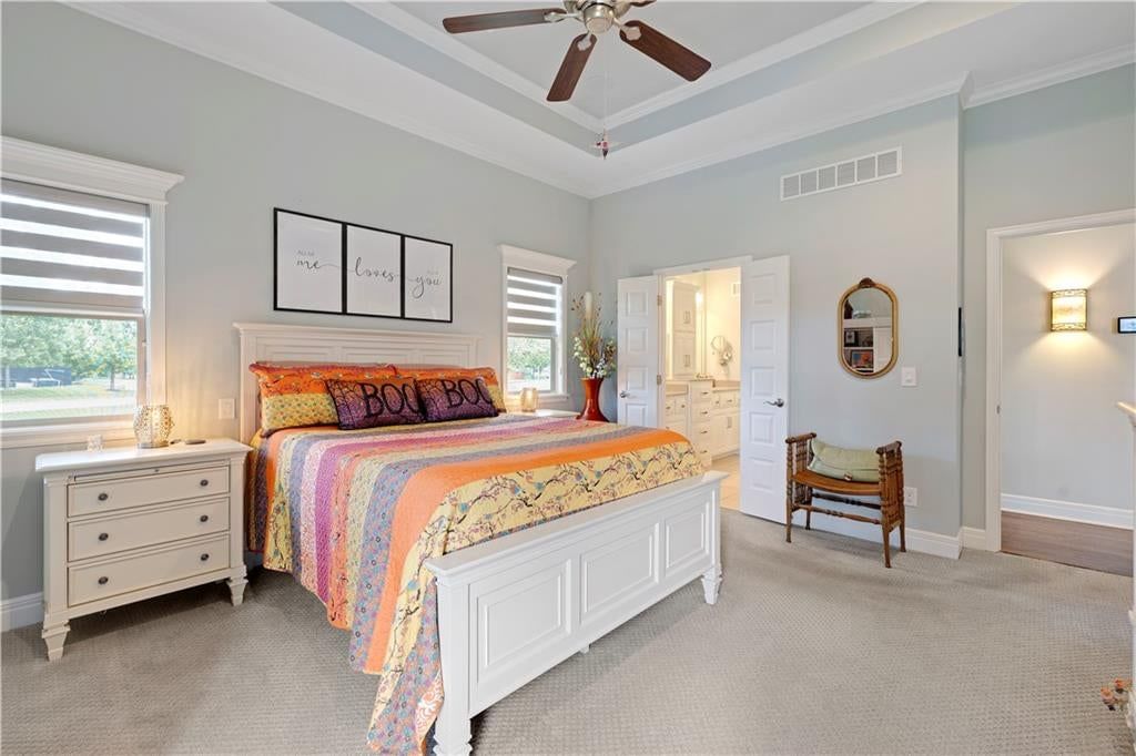 Main-floor primary bedroom, tray ceiling and carpet at 16300 S Britton Street, Olathe, KS 66062