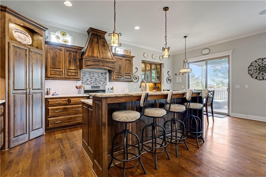 Kitchen island, statement lighting and kitchen backsplash at 16300 S Britton Street, Olathe, KS 66062