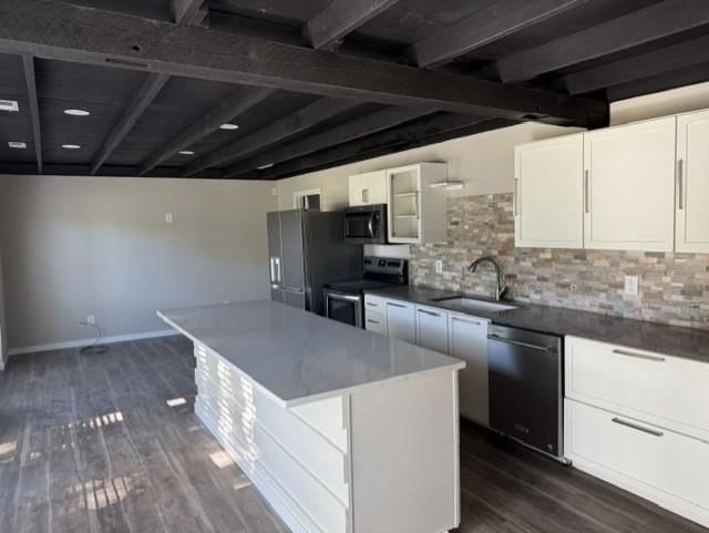 Stainless steel appliances, kitchen backsplash and mosaic tile backsplash at 409 Holden Street, East Lynne, MO 64743