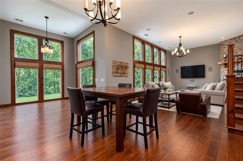 Floor-to-ceiling windows and statement lighting at 10245 Magnolia Lane, Parkville, MO 64152