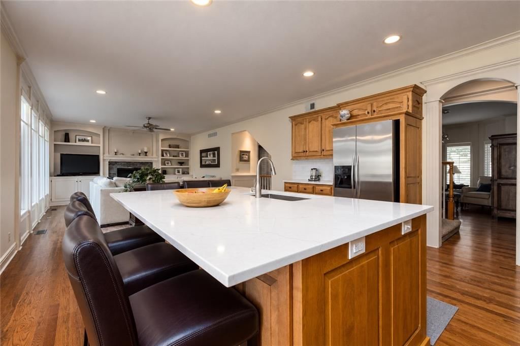 Kitchen island, stainless steel appliances and updated kitchen at 10245 Magnolia Lane, Parkville, MO 64152