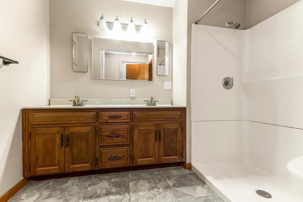 Walk-in shower and double vanity at 11801 E 45TH Terrace, Kansas City, MO 64133