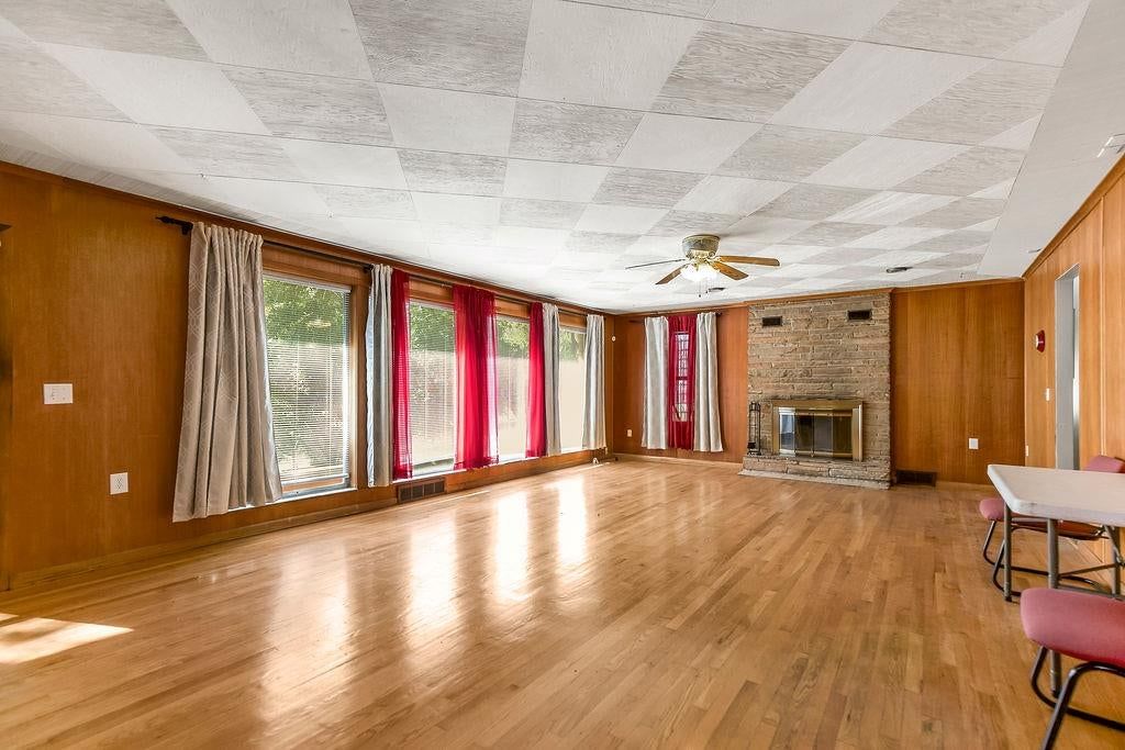 Fireplace, hardwood floors and brick fireplace at 11801 E 45TH Terrace, Kansas City, MO 64133