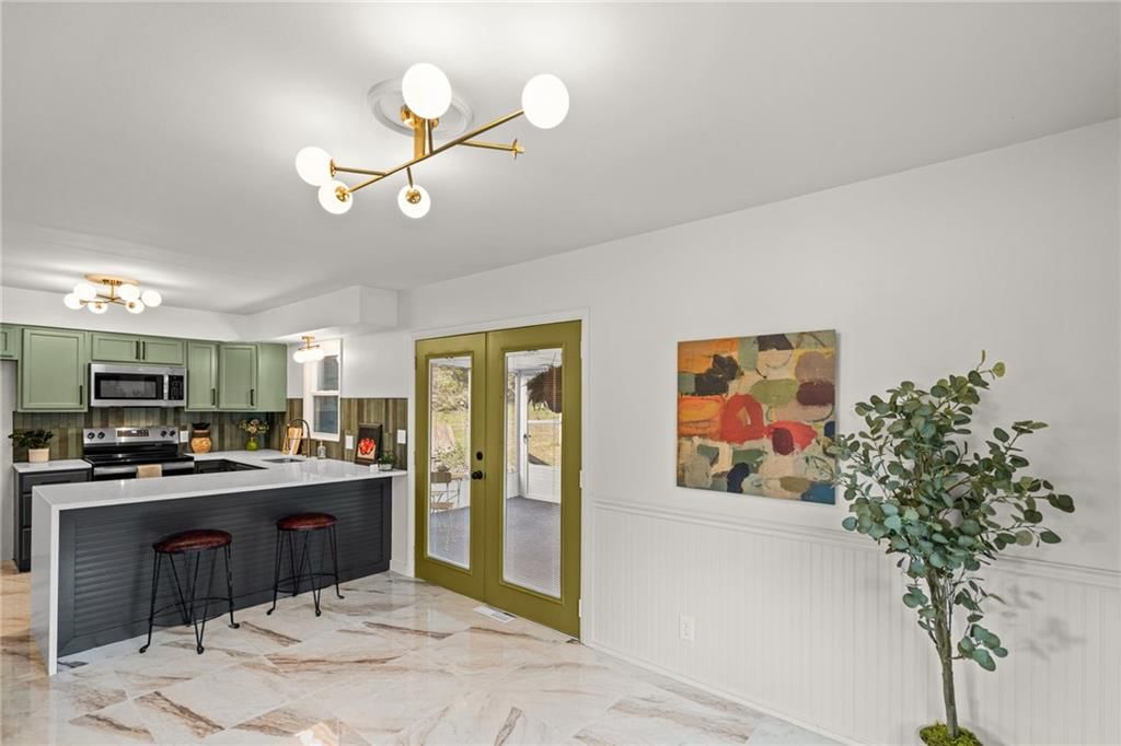 Open floor plan, kitchen island and breakfast nook at 7312 Hedges Avenue, Raytown, MO 64133