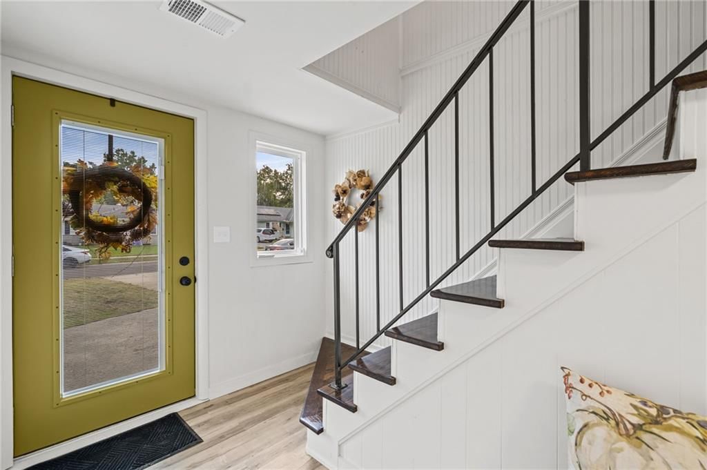 Shiplap / paneling, staircase and iron stair railing at 7312 Hedges Avenue, Raytown, MO 64133