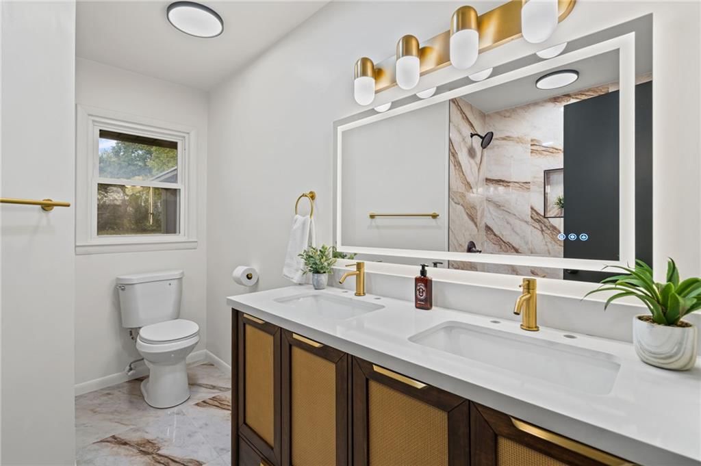 Double vanity and renovated bathrooms at 7312 Hedges Avenue, Raytown, MO 64133