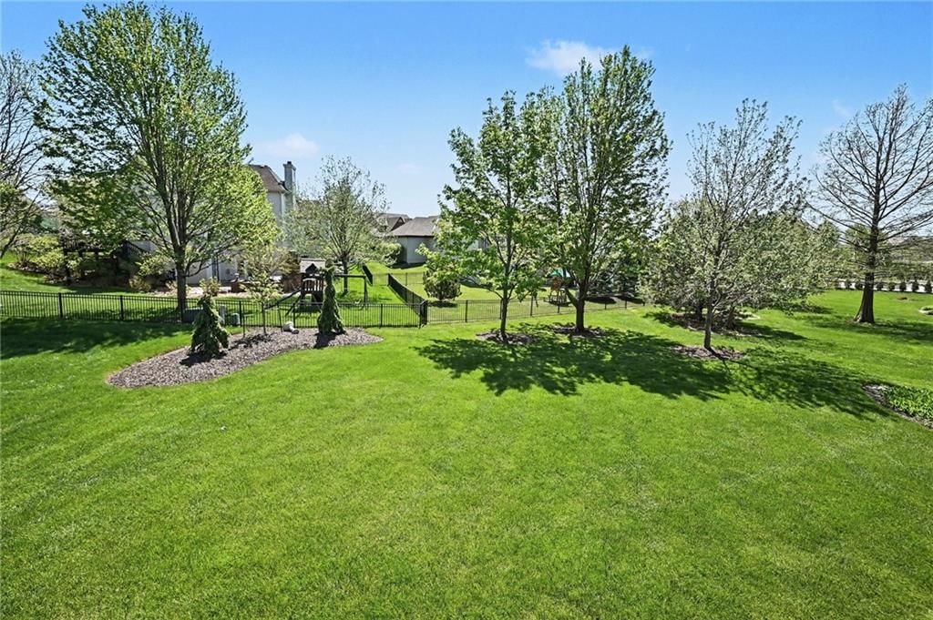 Big backyard, fenced yard and mature trees at 10139 N Montgall Avenue, Kansas City, MO 64155