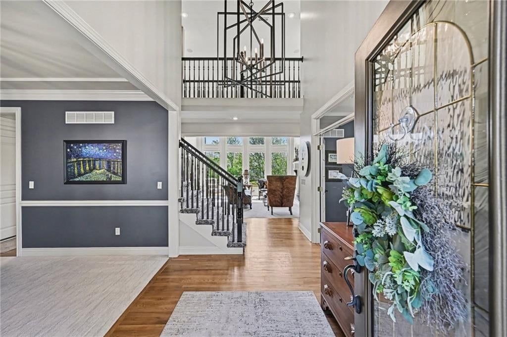 Hardwood floors, statement lighting and staircase at 10139 N Montgall Avenue, Kansas City, MO 64155