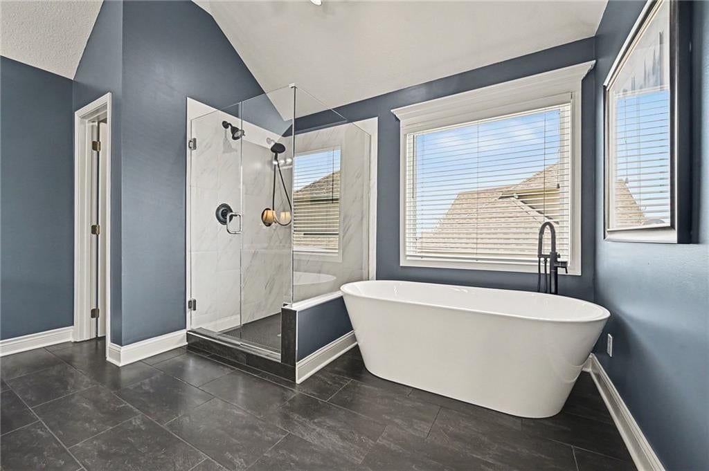 Walk-in shower, freestanding tub and tiled shower at 10139 N Montgall Avenue, Kansas City, MO 64155