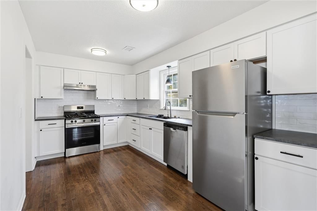 White kitchen, quartz counters and gas range at 307B E Main Street, Smithville, MO 64089