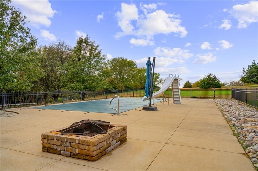 Fenced yard, fire pit and iron fence at 9260 Oakcrest Drive, Lenexa, KS 66227
