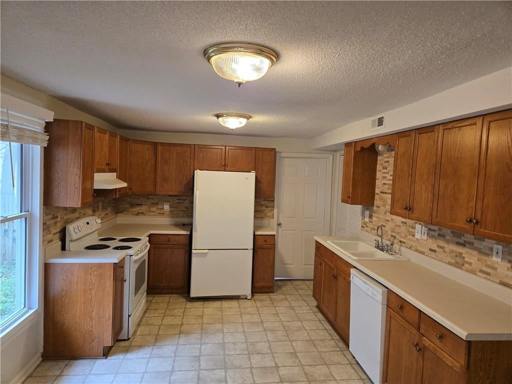 Second kitchen, tile floors and wood kitchen cabinets at 100 S Willis Avenue, Independence, MO 64050