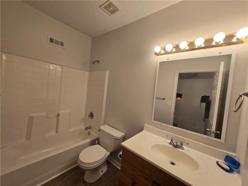 Tiled shower, brown vanity color and tub and shower combo at 100 S Willis Avenue, Independence, MO 64050