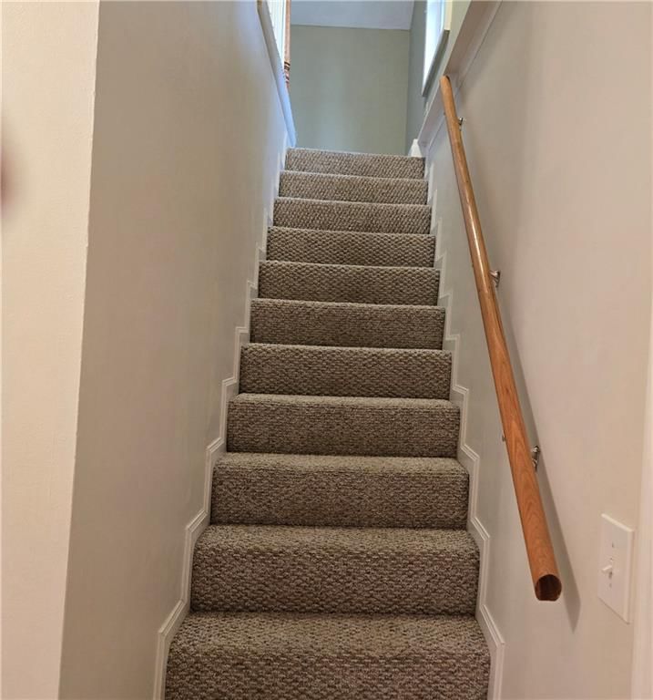 Staircase and wood stair railing at 100 S Willis Avenue, Independence, MO 64050