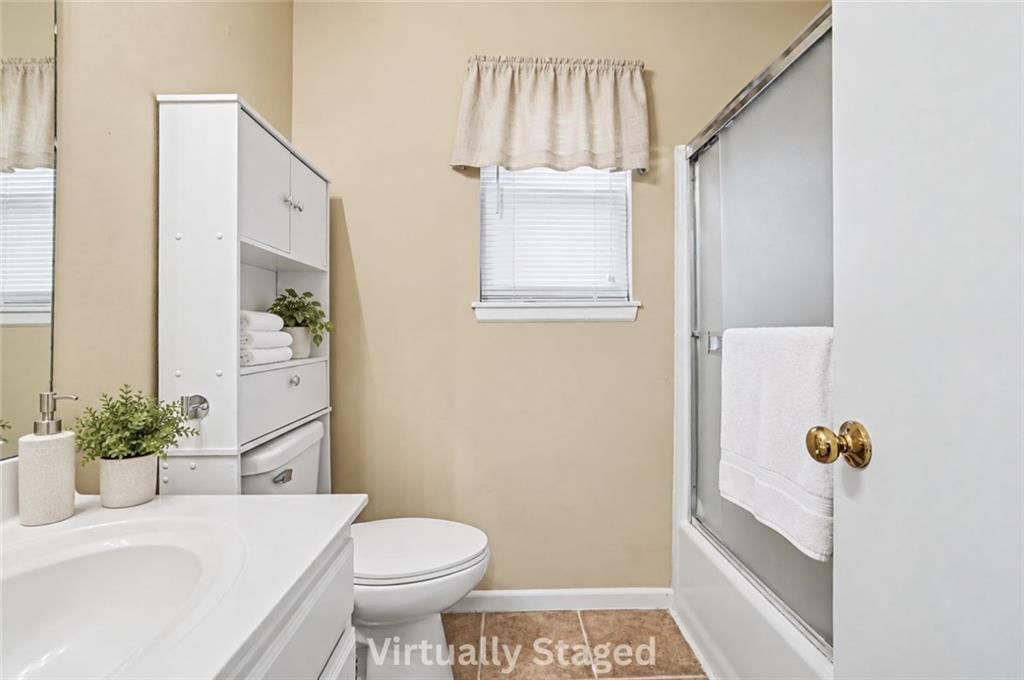 Tiled shower and renovated bathrooms at 17405 MONTGALL Drive, Belton, MO 64012