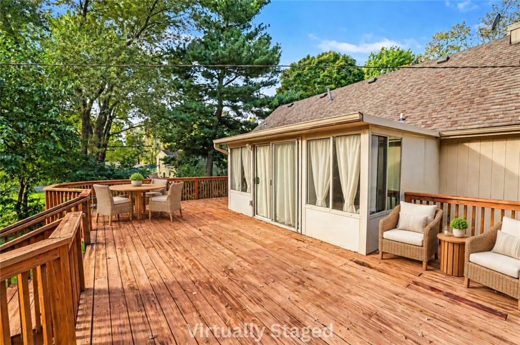 Deck, mature trees and wood deck at 17405 MONTGALL Drive, Belton, MO 64012