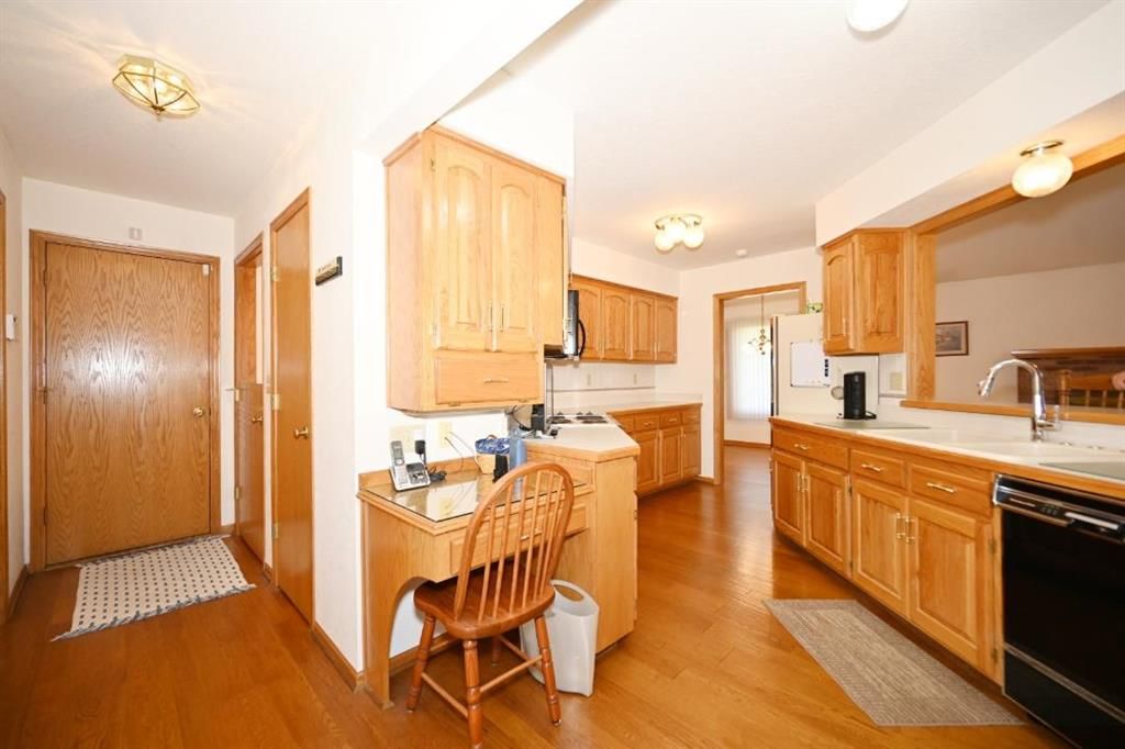 Wood kitchen cabinets, kitchen backsplash and mixed-finish appliances at 14 Pine View Road, Platte City, MO 64079